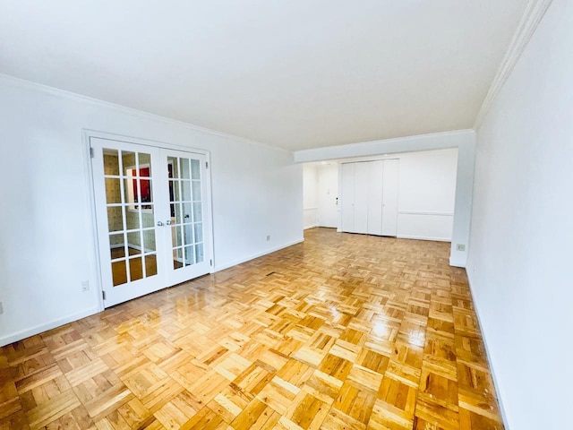 empty room with french doors, baseboards, and crown molding