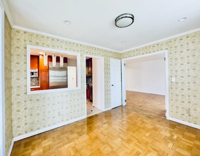 empty room featuring wallpapered walls, baseboards, and ornamental molding