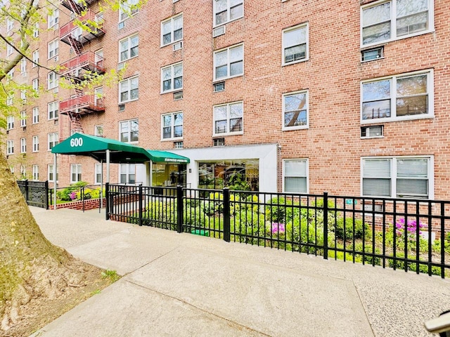 view of apartment building / complex with fence