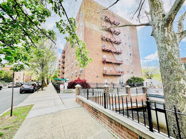 view of apartment building / complex with fence