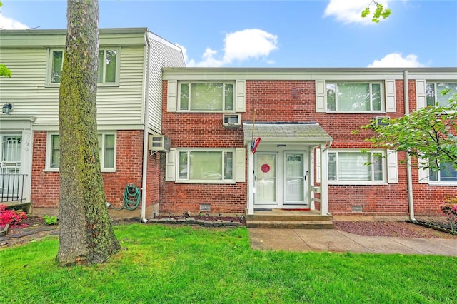13-10 212th St Unit 118, Bayside, NY 11360 - multi unit property featuring brick siding, crawl space, a front lawn, and a wall mounted air conditioner