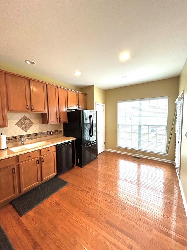 19 Brighton Dr Unit 1703, Newburgh, NY 12550 - kitchen featuring black appliances, light wood-style floors, baseboards, decorative backsplash, and recessed lighting