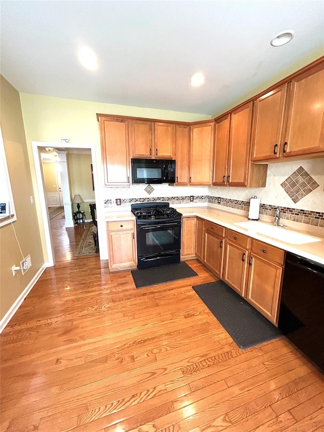 19 Brighton Dr Unit 1703, Newburgh, NY 12550 - kitchen featuring black appliances, light wood finished floors, backsplash, a sink, and recessed lighting