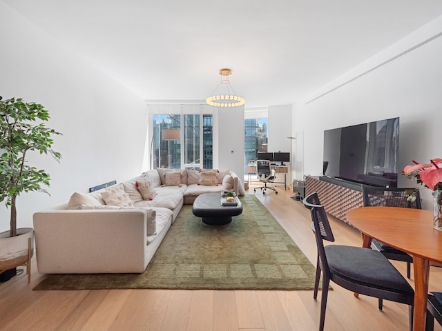 1 W End Ave Unit 26D, New York Manhattan, NY 10023 - living room with wood finished floors, a wall of windows, an office area, and a chandelier