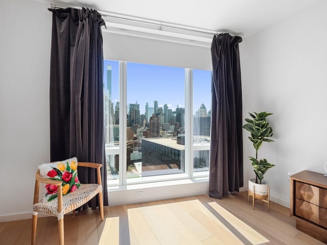 1 W End Ave Unit 26D, New York Manhattan, NY 10023 - living area with wood finished floors, plenty of natural light, a skyline view, and baseboards