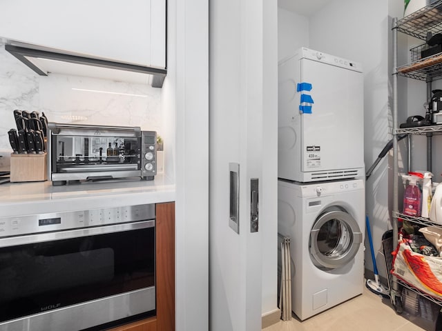 1 W End Ave Unit 26D, New York Manhattan, NY 10023 - washroom featuring stacked washer / dryer