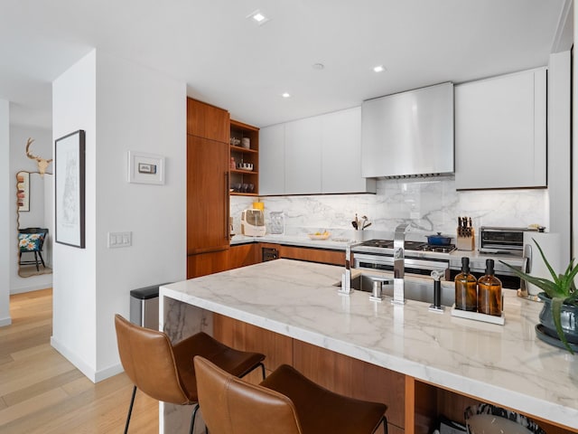 1 W End Ave Unit 26D, New York Manhattan, NY 10023 - kitchen featuring wall chimney range hood, modern cabinets, open shelves, a kitchen bar, and backsplash
