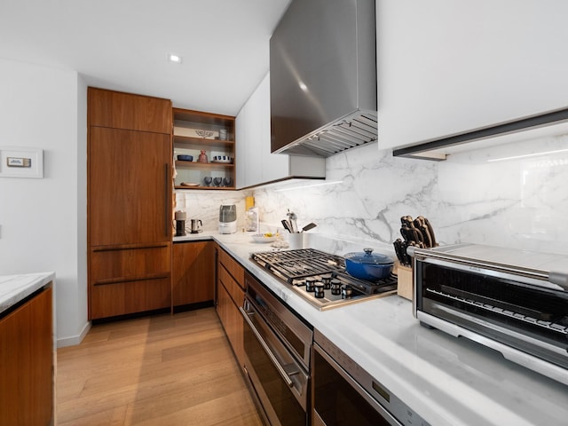 1 W End Ave Unit 26D, New York Manhattan, NY 10023 - kitchen with stainless steel appliances, wall chimney range hood, brown cabinets, and modern cabinets