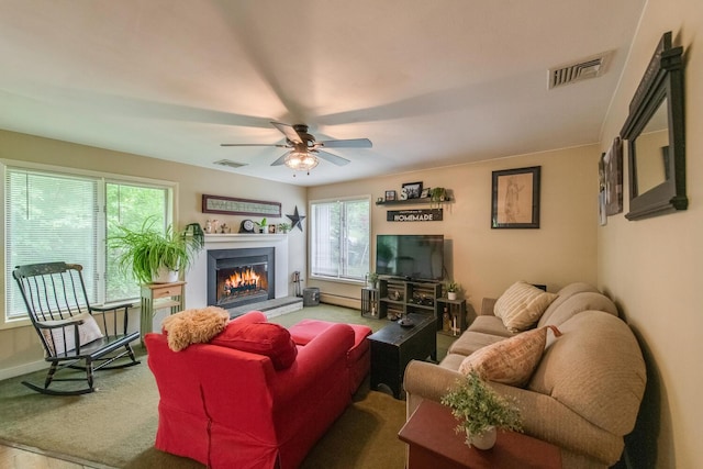 15 Marshall Dr, Poughkeepsie, NY 12601 - living room featuring a warm lit fireplace, a ceiling fan, and baseboards
