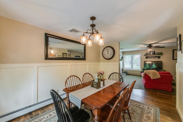 15 Marshall Dr, Poughkeepsie, NY 12601 - dining room with baseboard heating, a wainscoted wall, a chandelier, ceiling fan, and a decorative wall