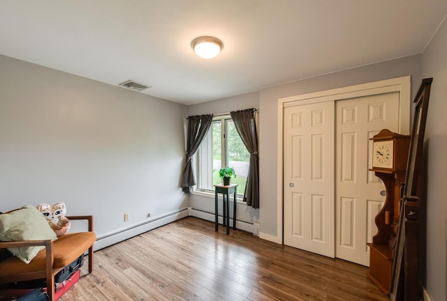 15 Marshall Dr, Poughkeepsie, NY 12601 - living area featuring wood finished floors and a baseboard radiator
