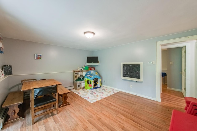 15 Marshall Dr, Poughkeepsie, NY 12601 - game room with wood finished floors, a baseboard heating unit, a baseboard radiator, and baseboards