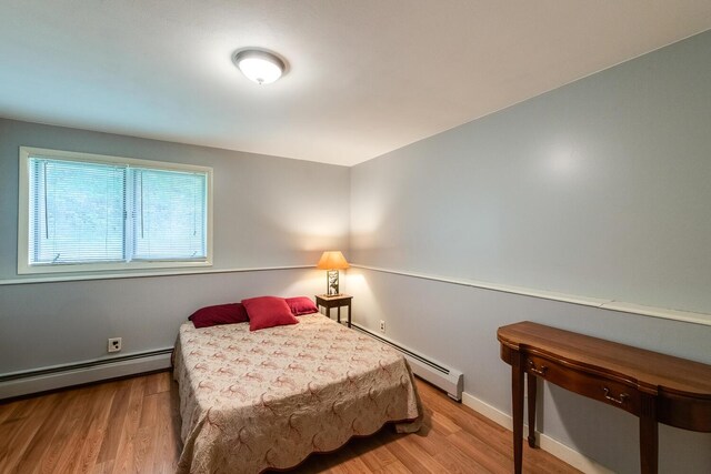 15 Marshall Dr, Poughkeepsie, NY 12601 - bedroom with a baseboard heating unit, wood finished floors, and baseboards