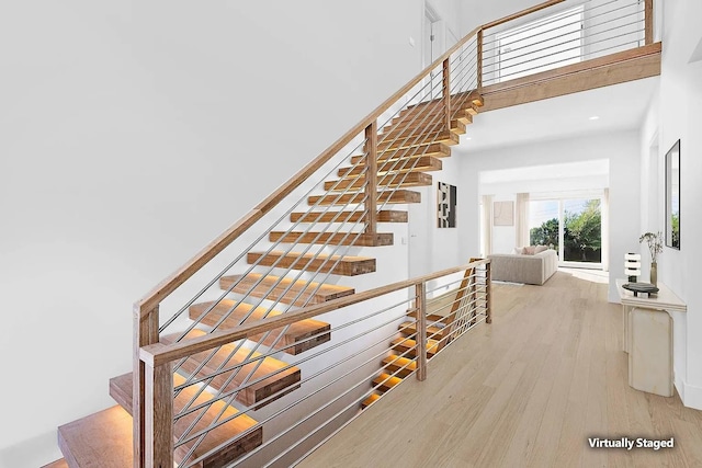 3 Dellaria Ave, Southampton, NY 11968 - stairway with a towering ceiling and wood finished floors
