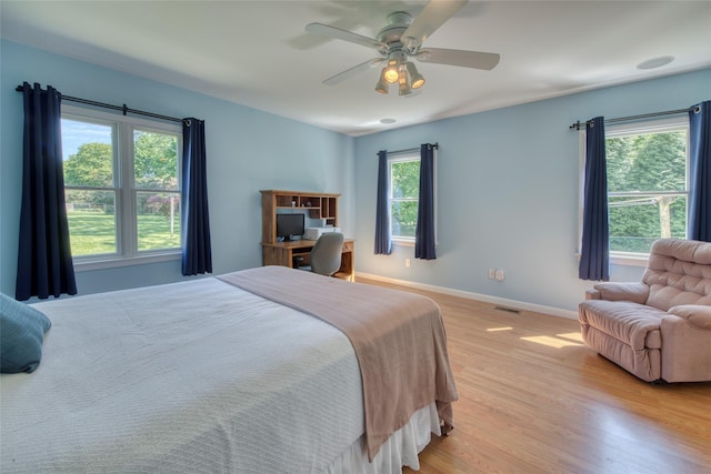 31 Bayberry Ln, Sag Harbor, NY 11963 - bedroom with light wood-style flooring, baseboards, ceiling fan, and a desk
