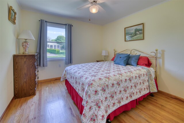 31 Bayberry Ln, Sag Harbor, NY 11963 - bedroom with light wood-type flooring, baseboards, crown molding, and a ceiling fan