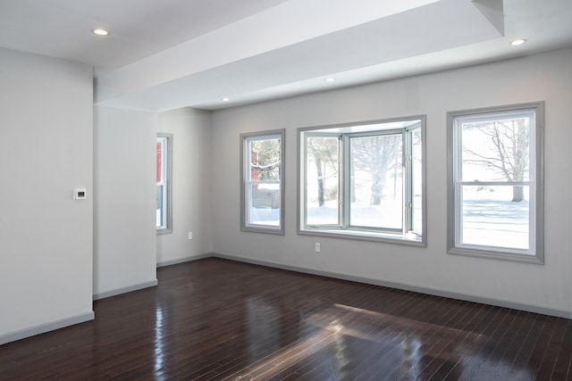 spare room with dark wood-type flooring, baseboards, and recessed lighting