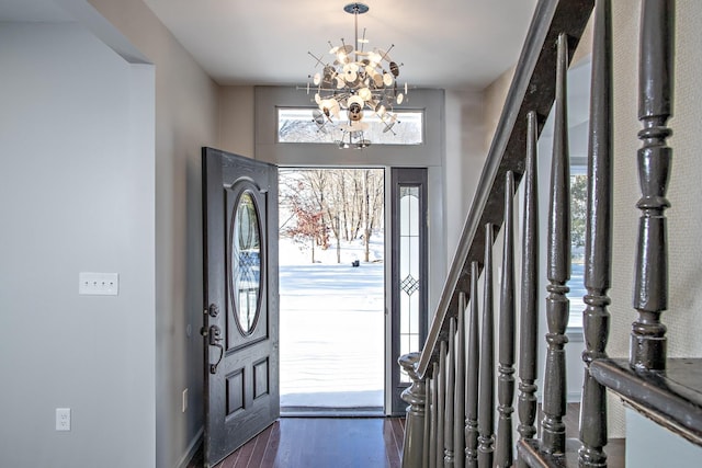foyer featuring a chandelier and wood finished floors