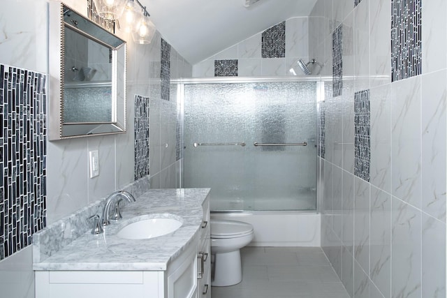 bathroom with tile walls, vanity, enclosed tub / shower combo, lofted ceiling, and toilet