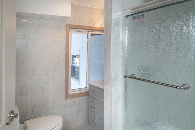 full bath featuring tile walls, toilet, and a shower stall