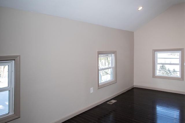 unfurnished room featuring lofted ceiling, dark wood finished floors, baseboards, and recessed lighting