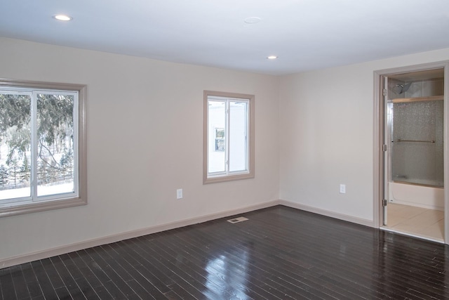 unfurnished bedroom featuring dark wood-type flooring, baseboards, and recessed lighting