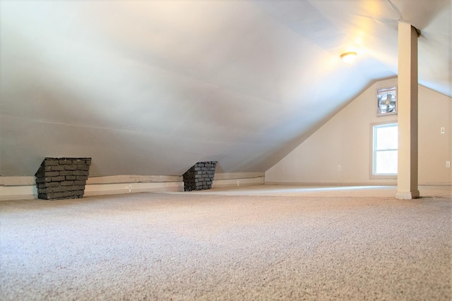 bonus room featuring carpet floors and vaulted ceiling