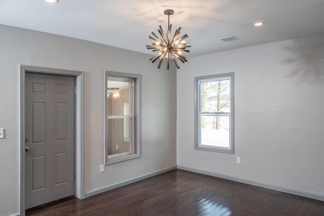 unfurnished room with a chandelier, dark wood-type flooring, baseboards, and recessed lighting