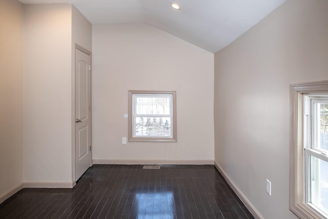 spare room with dark wood-style flooring, baseboards, lofted ceiling, and recessed lighting