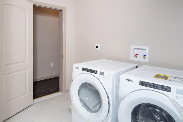 clothes washing area with separate washer and dryer