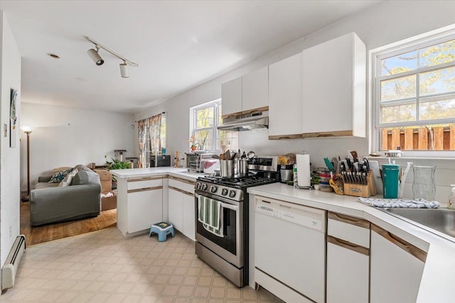 53 Shore Rd, Hampton Bays, NY 11946 - kitchen with dishwasher, stainless steel range with gas stovetop, a baseboard radiator, under cabinet range hood, and light countertops