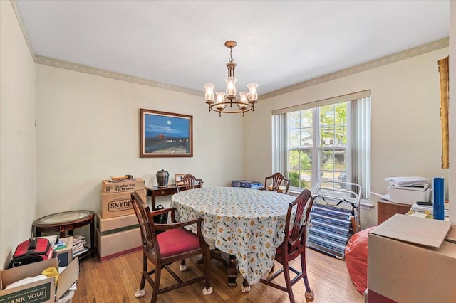53 Shore Rd, Hampton Bays, NY 11946 - dining space with a chandelier and light wood-style flooring