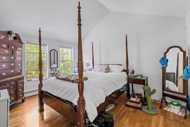 53 Shore Rd, Hampton Bays, NY 11946 - bedroom with vaulted ceiling, baseboard heating, and light wood-type flooring