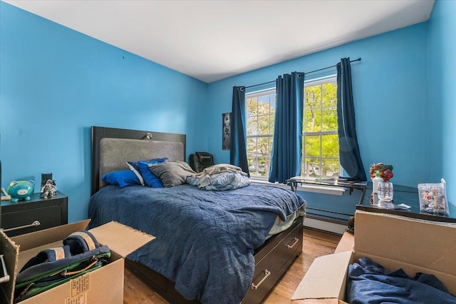 53 Shore Rd, Hampton Bays, NY 11946 - bedroom with baseboard heating and light wood-style floors