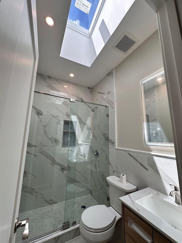 40 Allen St, New Hyde Park, NY 11040 - full bath featuring a skylight, a marble finish shower, toilet, vanity, and recessed lighting