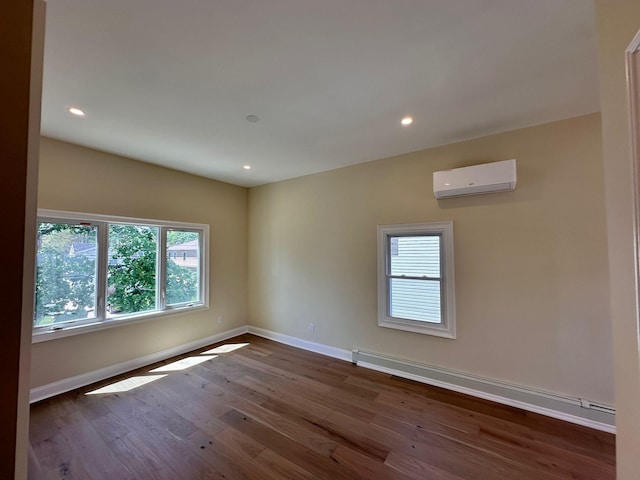 40 Allen St, New Hyde Park, NY 11040 - empty room with a wall mounted AC, a baseboard heating unit, healthy amount of natural light, baseboards, and recessed lighting