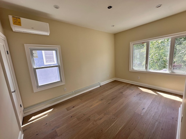 40 Allen St, New Hyde Park, NY 11040 - empty room with an AC wall unit, baseboards, and wood finished floors