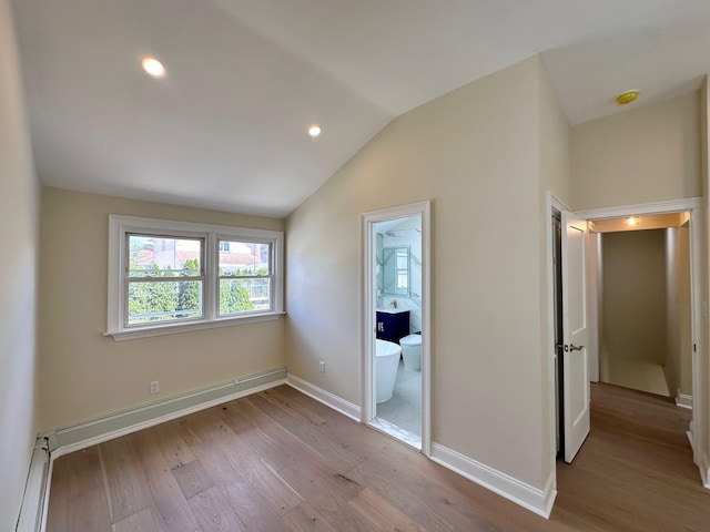 40 Allen St, New Hyde Park, NY 11040 - unfurnished bedroom with baseboard heating, wood finished floors, vaulted ceiling, baseboards, and recessed lighting