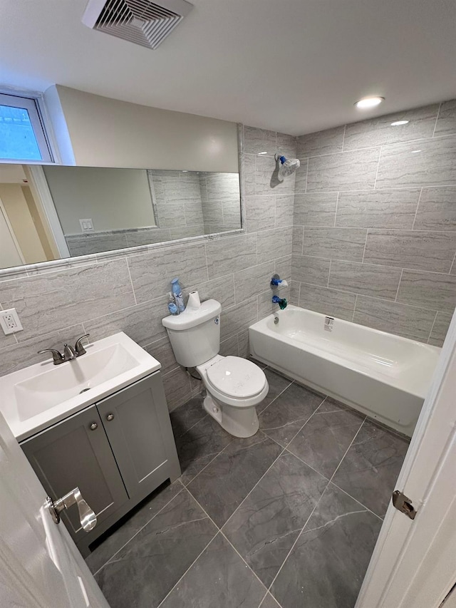 40 Allen St, New Hyde Park, NY 11040 - bathroom featuring vanity, toilet, tile walls, washtub / shower combination, and marble finish flooring