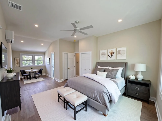 40 Allen St, New Hyde Park, NY 11040 - bedroom featuring wood finished floors, baseboards, two closets, recessed lighting, and vaulted ceiling