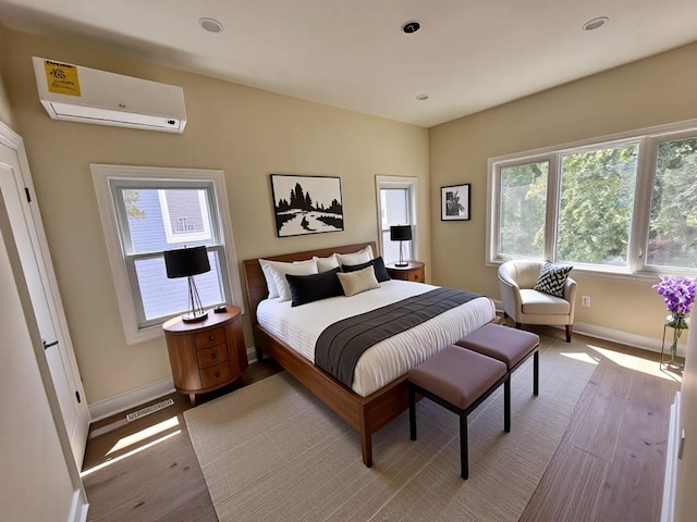 40 Allen St, New Hyde Park, NY 11040 - bedroom with a wall mounted AC, light wood-style flooring, baseboards, and recessed lighting