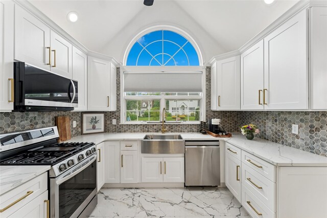694 The Fenway, Baldwin, NY 11510 - kitchen with stainless steel appliances, a sink, light marble finish flooring, vaulted ceiling, and healthy amount of natural light