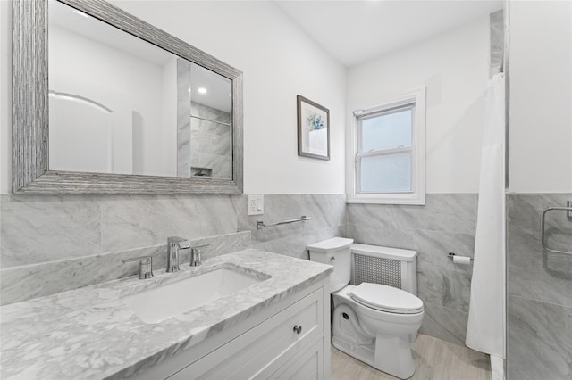 694 The Fenway, Baldwin, NY 11510 - bathroom featuring tile walls, toilet, vanity, a shower, and wainscoting