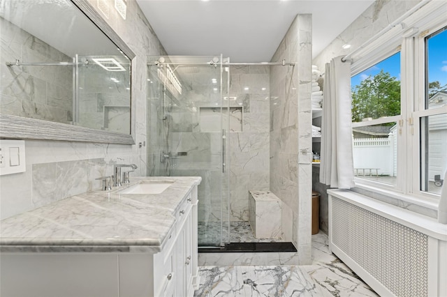 694 The Fenway, Baldwin, NY 11510 - bathroom with radiator heating unit, marble tiled flooring, a marble finish shower, vanity, and tile walls