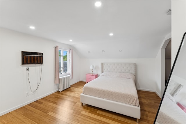 694 The Fenway, Baldwin, NY 11510 - bedroom with radiator heating unit, vaulted ceiling, light wood-style flooring, baseboards, and recessed lighting
