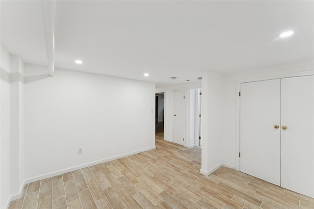 694 The Fenway, Baldwin, NY 11510 - below grade area featuring recessed lighting, light wood-style floors, and baseboards