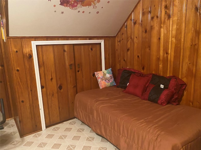 bedroom featuring wood walls