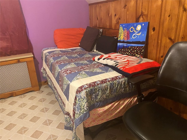 bedroom featuring wood walls