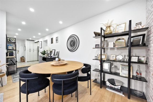 dining space with light wood-style floors and recessed lighting
