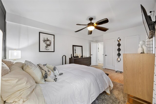 bedroom with light wood finished floors and ceiling fan